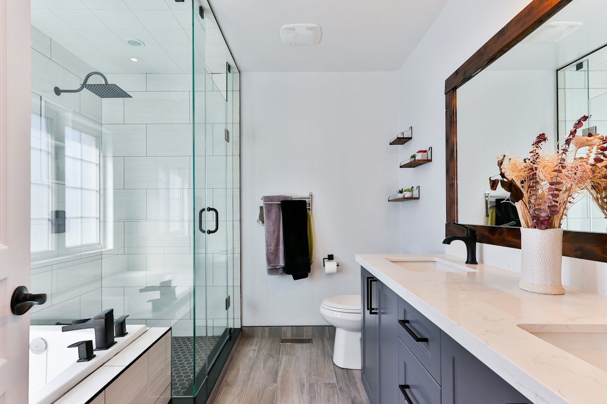 Glass walk-in shower with white tile